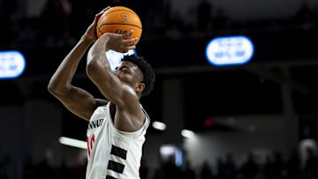 Feb 25, 2025; Cincinnati, Ohio, USA;  Cincinnati Bearcats guard Josh Reed (10) shoots against the Baylor Bears in the first half at Fifth Third Arena. Mandatory Credit: Aaron Doster-Imagn Images