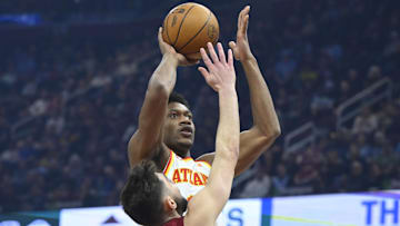 Jan 30, 2025; Cleveland, Ohio, USA; Atlanta Hawks forward De'Andre Hunter (12) shoots beside Cleveland Cavaliers guard Ty Jerome (2) in the first quarter at Rocket Mortgage FieldHouse. Mandatory Credit: David Richard-Imagn Images