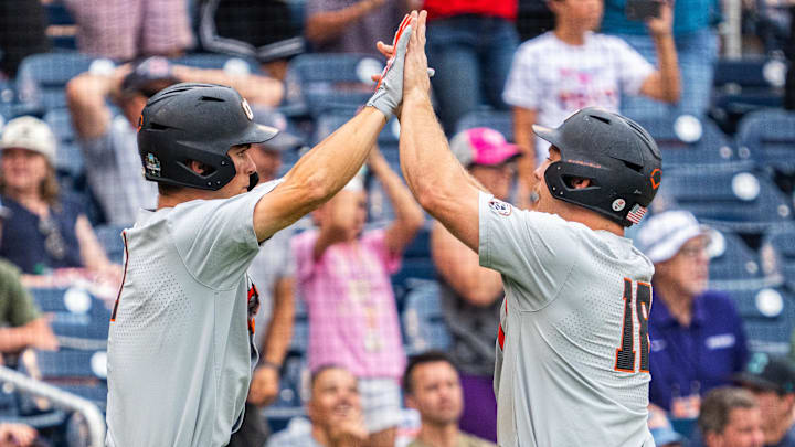 Jun 17, 2025; Omaha, Neb, USA; Oregon State Beavers catcher Wilson Weber (18) and left fielder Gavin Turley (1) celebrate after scoring two runs to tie the game against the Louisville Cardinals during the ninth inning at Charles Schwab Field. Mandatory Credit: Dylan Widger-Imagn Images Jun 17, 2025; Omaha, Neb, USA; Oregon State Beavers catcher Wilson Weber (18) and left fielder Gavin Turley (1) celebrate after scoring two runs to tie the game against the Louisville Cardinals during the ninth inning at Charles Schwab Field. Mandatory Credit: Dylan Widger-Imagn Images