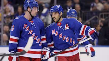 Nov 10, 2025; New York, New York, USA; New York Rangers center Vincent Trocheck (16) talks to left wing Alexis Lafreniere (13) during the first period against the Nashville Predators at Madison Square Garden. Mandatory Credit: Brad Penner-Imagn Images