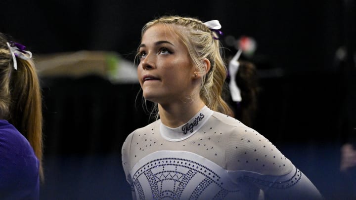 Apr 20, 2024: LSU Tigers gymnast Livvy Dunne watches as LSU Tigers gymnast Haleigh Bryant performs on uneven bars during the 2024 Women's National Gymnastics Championship.