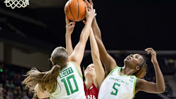 Oregon guard Peyton Scott, left, Indiana guard Yarden Garzon, and Oregon forward Amina Muhammad leap to rebound the ball as the Oregon Ducks host the Indiana Hoosiers Friday, Jan. 24, 2025, at Matthew Knight Arena in Eugene, Ore.