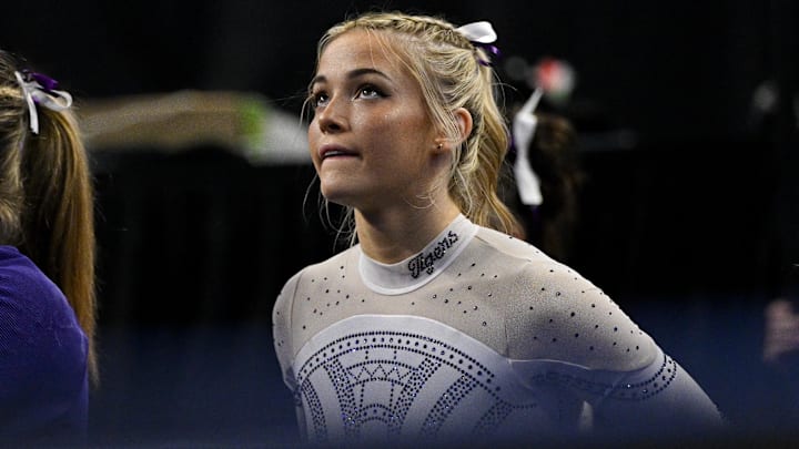 LSU Tigers gymnast Olivia Dunne watches as LSU Tigers gymnast Haleigh Bryant performs on uneven bars during the 2024 Womens National Gymnastics Championship at Dickies Arena.