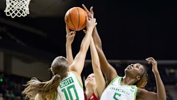 Oregon guard Peyton Scott, left, Indiana guard Yarden Garzon, and Oregon forward Amina Muhammad leap to rebound the ball as the Oregon Ducks host the Indiana Hoosiers Friday, Jan. 24, 2025, at Matthew Knight Arena in Eugene, Ore.