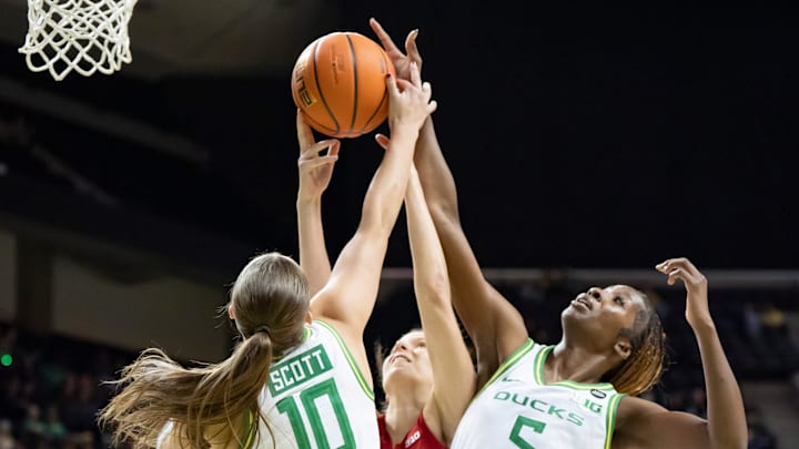 Oregon guard Peyton Scott, left, Indiana guard Yarden Garzon, and Oregon forward Amina Muhammad leap to rebound the ball as the Oregon Ducks host the Indiana Hoosiers Friday, Jan. 24, 2025, at Matthew Knight Arena in Eugene, Ore.
