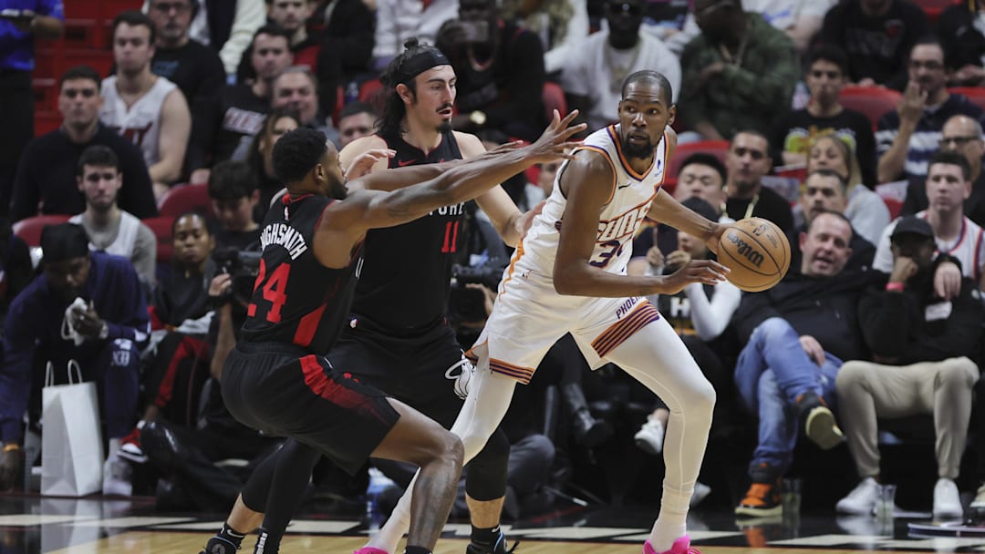 Jan 29, 2024; Miami, Florida, USA; Phoenix Suns forward Kevin Durant (35) protects the basketball from Miami Heat forward Haywood Highsmith (24) and guard Jaime Jaquez Jr. (11) during the third quarter at Kaseya Center. Mandatory Credit: Sam Navarro-Imagn Images