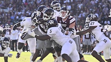 Oct 1, 2022; Starkville, Mississippi, USA; Mississippi State Bulldogs running back Dillon Johnson (23) is stopped short of the goal line by Texas A&M Aggies defensive lineman Shemar Turner (5) during the second quarter at Davis Wade Stadium at Scott Field. Mandatory Credit: Matt Bush-Imagn Images