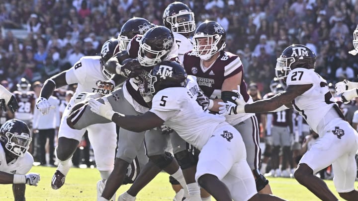 Oct 1, 2022; Starkville, Mississippi, USA; Mississippi State Bulldogs running back Dillon Johnson (23) is stopped short of the goal line by Texas A&M Aggies defensive lineman Shemar Turner (5) during the second quarter at Davis Wade Stadium at Scott Field. Mandatory Credit: Matt Bush-USA TODAY Sports