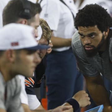 Caleb Williams listens in with Shane Waldron and the QBs at Thursday's game in Canton even though he wasn't playing.