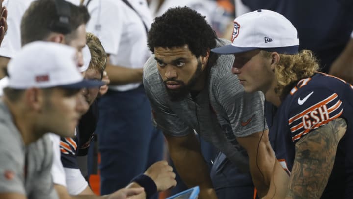 Caleb Williams listens in with Shane Waldron and the QBs at Thursday's game in Canton even though he wasn't playing.