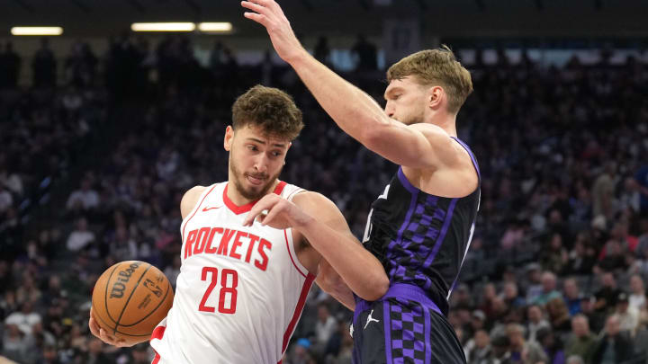 Mar 10, 2024; Sacramento, California, USA; Houston Rockets center Alperen Sengun (28) drives against Sacramento Kings forward Domantas Sabonis (right) during the third quarter at Golden 1 Center. Mandatory Credit: Darren Yamashita-USA TODAY Sports