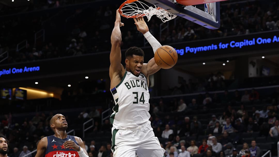 Dec 1, 2025; Washington, District of Columbia, USA; Milwaukee Bucks forward Giannis Antetokounmpo (34) dunks the ball as Washington Wizards forward Khris Middleton (22) looks on in the second quarter at Capital One Arena. Mandatory Credit: Geoff Burke-Imagn Images