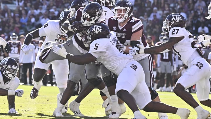 Oct 1, 2022; Starkville, Mississippi, USA; Mississippi State Bulldogs running back Dillon Johnson (23) is stopped short of the goal line by Texas A&M Aggies defensive lineman Shemar Turner (5) during the second quarter at Davis Wade Stadium at Scott Field. Mandatory Credit: Matt Bush-USA TODAY Sports