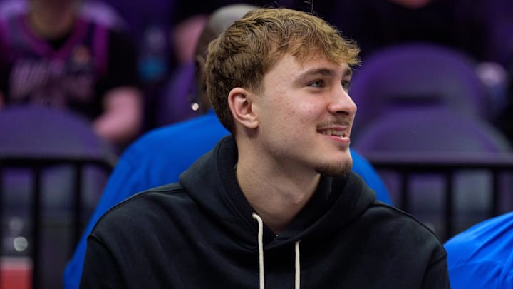 Feb 20, 2026; Minneapolis, Minnesota, USA; Dallas Mavericks forward Cooper Flagg (32) watches the second quarter against the Minnesota Timberwolves at Target Center. 