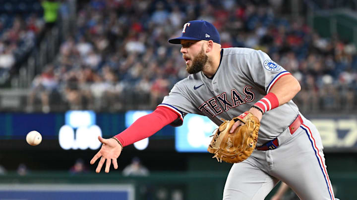 Jun 6, 2025; Washington, District of Columbia, USA; Texas Rangers first baseman Jake Burger (21) tosses the ball to first base during the eighth inning against the Washington Nationals at Nationals Park. 