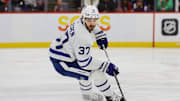 Apr 16, 2024; Sunrise, Florida, USA; Toronto Maple Leafs defenseman Timothy Liljegren (37) moves the puck against the Florida Panthers during the second period at Amerant Bank Arena. Mandatory Credit: Sam Navarro-Imagn Images