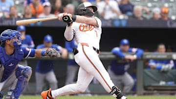 May 4, 2025; Baltimore, Maryland, USA; Baltimore Orioles second baseman Jackson Holliday (7) hits a single against the Kansas City Royals during the eighth inning at Oriole Park at Camden Yards. 