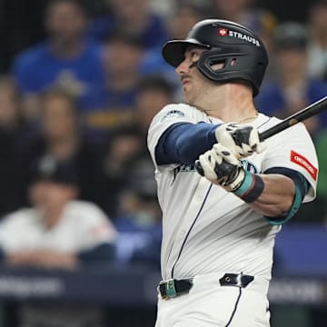 Oct 10, 2025; Seattle, Washington, USA; Seattle Mariners designated hitter Mitch Garver (18) hits a sacrifice fly against the Detroit Tigers during the second inning during game five of the ALDS round for the 2025 MLB playoffs at T-Mobile Park. Mandatory Credit: Stephen Brashear-Imagn Images