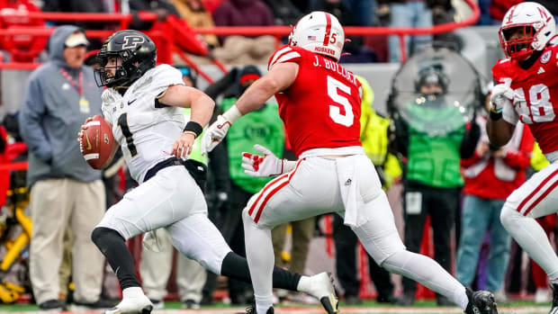 Purdue Boilermakers quarterback Hudson Card (1) runs against Nebraska Cornhuskers linebacker John Bullock (5)