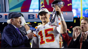 Feb 12, 2023; Glendale, Arizona, US; Kansas City Chiefs quarterback Patrick Mahomes (15) celebrates with the Vince Lombardi Trophy alongside Fox host Terry Bradshaw after defeating the Philadelphia Eagles during Super Bowl LVII at State Farm Stadium. Mandatory Credit: Mark J. Rebilas-Imagn Images