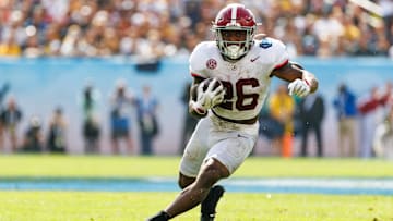 Dec 31, 2024; Tampa, FL, USA; Alabama Crimson Tide running back Jam Miller (26) rushes with the ball against the Michigan Wolverines during the first half at Raymond James Stadium. Mandatory Credit: Matt Pendleton-Imagn Images