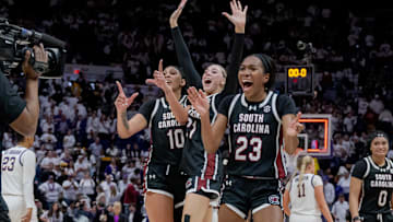 South Carolina basketball frontcourt members Kamilla Cardoso, Chloe Kitts, and Bree Hall after the final buzzer against LSU.