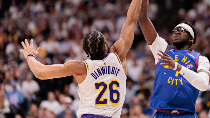 Apr 20, 2024; Denver, Colorado, USA; Denver Nuggets guard Reggie Jackson (7) shoots the ball against Los Angeles Lakers guard Spencer Dinwiddie (26) during the second quarter in game one of the first round for the 2024 NBA playoffs at Ball Arena. Mandatory Credit: Andrew Wevers-USA TODAY Sports