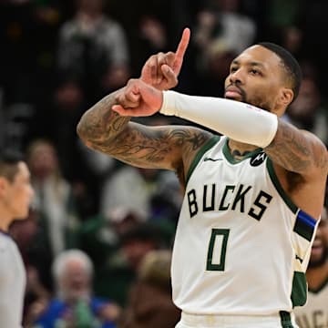 Jan 14, 2024; Milwaukee, Wisconsin, USA;  Milwaukee Bucks guard Damian Lillard (0) reacts after scoring the game-winning basket in overtime against the Sacramento Kings at Fiserv Forum. Mandatory Credit: Benny Sieu-Imagn Images