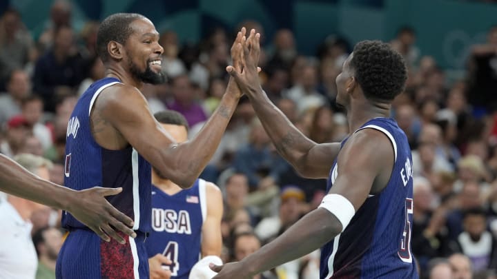 United States guard Kevin Durant (7) and guard Anthony Edwards (5) celebrate after a play  in the third quarter against Serbia during the Paris 2024 Olympic Summer Games at Stade Pierre-Mauroy. Mandatory Credit: John David Mercer-USA TODAY Sports