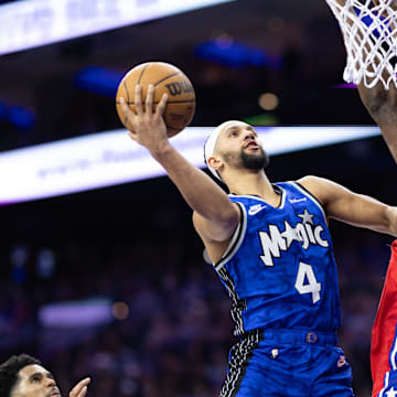 Orlando Magic guard Jalen Suggs (4) drives for a shot against Philadelphia 76ers center Joel Embiid (21) during the second quarter at Wells Fargo Center.