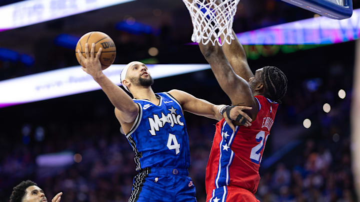 Orlando Magic guard Jalen Suggs (4) drives for a shot against Philadelphia 76ers center Joel Embiid (21) during the second quarter at Wells Fargo Center.