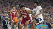 Apr 6, 2024; Glendale, AZ, USA;  Alabama Crimson Tide guard Aaron Estrada (55) drives against Connecticut Huskies guard Tristen Newton (2) in the semifinals of the men's Final Four of the 2024 NCAA Tournament at State Farm Stadium. Mandatory Credit: Robert Deutsch-USA TODAY Sports