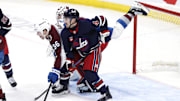 Nov 7, 2024; Winnipeg, Manitoba, CAN; Colorado Avalanche right wing Mikko Rantanen (96) and Winnipeg Jets defenseman Neal Pionk (4) collide in front of goaltender Connor Hellebuyck (37) in the third period at Canada Life Centre. Mandatory Credit: James Carey Lauder-Imagn Images