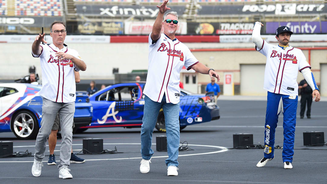 NASCAR’s Kevin Harvic, MLB’s Chipper Jones, and NASCAR’s Chase Elliott, throw a first pitch during a press conference announcing a game between the Atlanta Braves and the Cincinnati Reds at Bristol Motor Speedway, at Bristol Motor Speedway in Bristol, Tenn., Friday, Aug. 9, 2024.