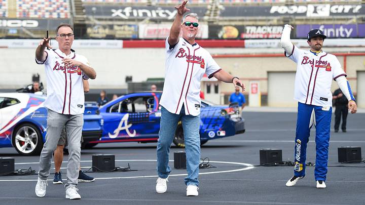 NASCAR’s Kevin Harvic, MLB’s Chipper Jones, and NASCAR’s Chase Elliott, throw a first pitch during a press conference announcing a game between the Atlanta Braves and the Cincinnati Reds at Bristol Motor Speedway, at Bristol Motor Speedway in Bristol, Tenn., Friday, Aug. 9, 2024.