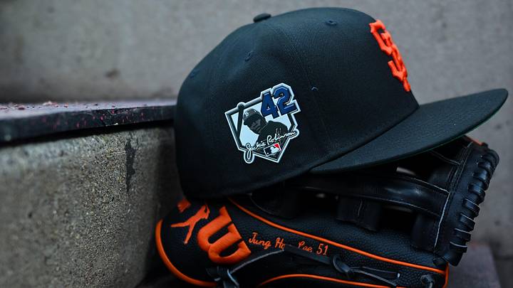 Apr 15, 2026; Cincinnati, Ohio, USA;  A view of a Giants game hat on the dugout steps, with a patch honoring Jackie Robinson during the game between the San Francisco Giants and the Cincinnati Reds at Great American Ball Park. Players and coaches will wear No. 42 in honor of Jackie Robinson Day around the league. Mandatory Credit: Aaron Doster-Imagn Images