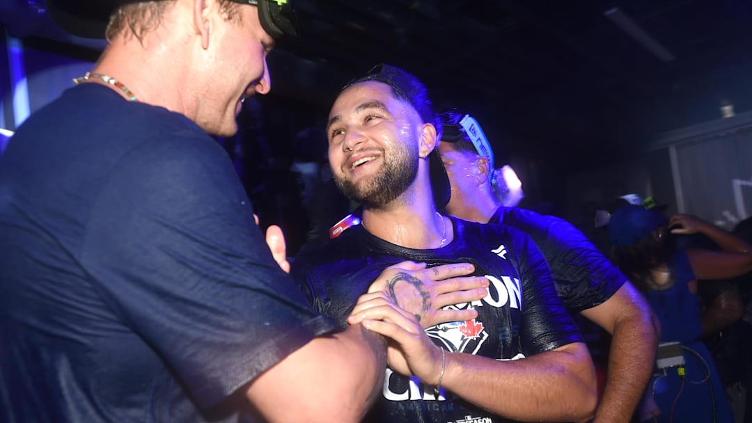 Sep 28, 2025; Toronto, Ontario, CAN;  Toronto Blue Jays shortstop Bo Bichette (11) celebrates with teammates after a win over the Tampa Bay Rays clinched first place in the American League East Division at Rogers Centre. Mandatory Credit: Dan Hamilton-Imagn Images