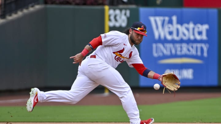 Jul 14, 2024; St. Louis, Missouri, USA;  St. Louis Cardinals third baseman Brandon Crawford (35) fields a ground ball against the Chicago Cubs during the eighth inning at Busch Stadium. 