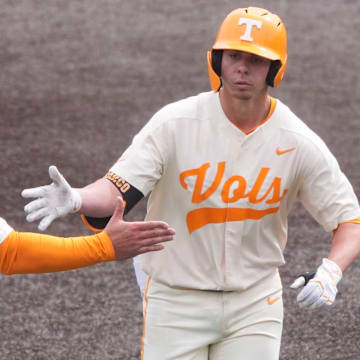 Tennessee's Dalton Bargo celebrating with associate head coach Josh Elander as he rounds the bases after hitting a home run in an NCAA college baseball game against St. Bonaventure on Sunday, March 9, 2025, in Knoxville, Tenn.