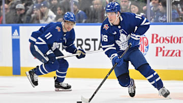 Jan 14, 2024; Toronto, Ontario, CAN;  Toronto Maple Leafs forward Mitchell Marner (16) skates with the puck as forward Max Domi (11) trails him in the third period against the Detroit Red Wings at Scotiabank Arena. Mandatory Credit: Dan Hamilton-Imagn Images
