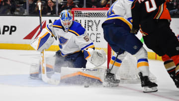 Apr 7, 2024; Anaheim, California, USA; St. Louis Blues goaltender Jordan Binnington (50) blocks a shot against Anaheim Ducks defenseman Cam Fowler (4) during the shootout at Honda Center. Mandatory Credit: Gary A. Vasquez-USA TODAY Sports