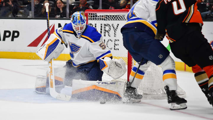 Apr 7, 2024; Anaheim, California, USA; St. Louis Blues goaltender Jordan Binnington (50) blocks a shot against Anaheim Ducks defenseman Cam Fowler (4) during the shootout at Honda Center. Mandatory Credit: Gary A. Vasquez-USA TODAY Sports