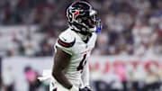 Sep 15, 2025; Houston, Texas, USA; Houston Texans cornerback Kamari Lassiter (4) celebrates after making a tackle during the fourth quarter against the Tampa Bay Buccaneers at NRG Stadium. Mandatory Credit: Thomas Shea-Imagn Images