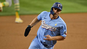 Sep 1, 2024; Arlington, Texas, USA; Texas Rangers shortstop Corey Seager (5) scores from second base on a double hit by right fielder Adolis Garcia (not pictured) during the first inning at Globe Life Field. Mandatory Credit: Jerome Miron-Imagn Images