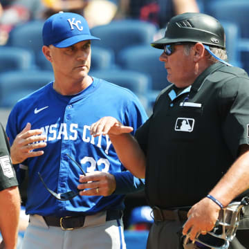 Aug 26, 2024; Cleveland, Ohio, USA; Kansas City Royals manager Matt Quatraro (33) talks with umpire Marvin Hudson, left, and umpire Hunter Wendelstedt during the fourth inning against the Cleveland Guardians at Progressive Field. Mandatory Credit: Ken Blaze-USA TODAY Sports