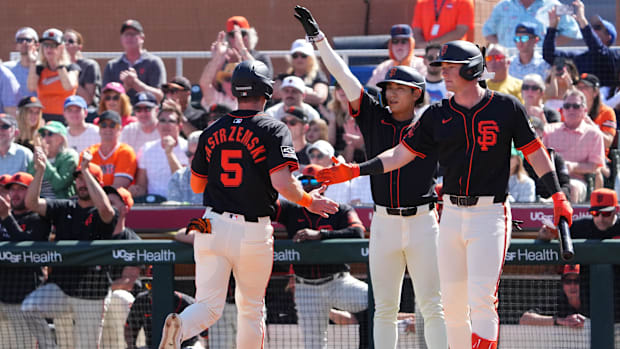 San Francisco Giants outfielder Mike Yastrzemski scores a run against the Los Angeles Angels during a spring training game.