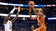 Texas A&M Aggies guard Manny Obaseki (35) guards while Texas Longhorns guard Tre Johnson (20) goes up for a layup during their second round game of the SEC Men's Basketball Tournament at Bridgestone Arena in Nashville, Tenn., Thursday, March 13, 2025.