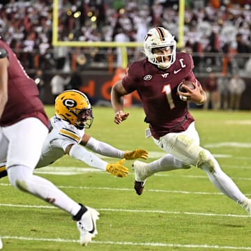Virginia Tech quarterback Kyron Drones (1) eludes Cal defensive back Jordan Sanford