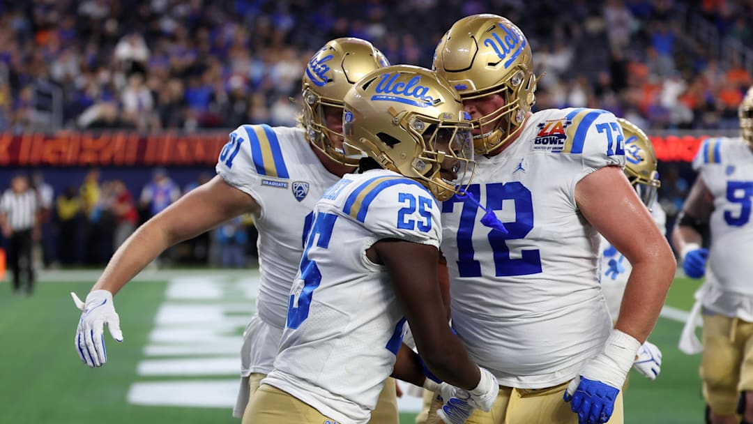 Dec 16, 2023; Inglewood, CA, USA; UCLA Bruins running back TJ Harden (25) celebrates with offensive lineman Garrett DiGiorgio (72) after scoring a touchdown during the third quarter of the LA Bowl at SoFi Stadium. Mandatory Credit: Kiyoshi Mio-Imagn Images