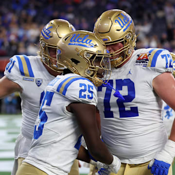 Dec 16, 2023; Inglewood, CA, USA; UCLA Bruins running back TJ Harden (25) celebrates with offensive lineman Garrett DiGiorgio (72) after scoring a touchdown during the third quarter of the LA Bowl at SoFi Stadium. Mandatory Credit: Kiyoshi Mio-Imagn Images